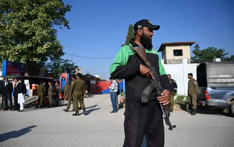 Police officials stand guard outside the Adiala Jail during the hearing of jailed former Pakistan prime minister Imran Khan, in Rawalpindi on October 23, 2023. Khan was on October 23 charged with leaking classified documents, a prosecutor said, a charge that carries a prison term of up to 14 years. (Photo by Aamir QURESHI / AFP)