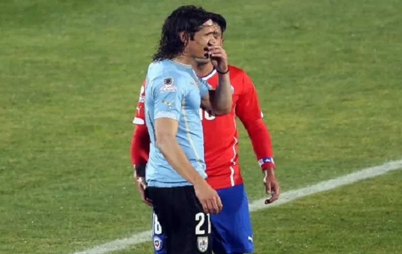 Chile's football team defender Gonzalo Jara (back)  provokes Uruguay's Edinson Cavani (front) during their Copa America 2015 quarterfinals football match in Santiago, on June 24, 2015. A broadcast footage shows Chilean player Gonzalo Jara attempting to provoke the star by inserting a finger into his anus. Uruguay's coach Oscar Tabarez said Cavani had been the victim of provocation by Jara which should have been spotted by the match officials.  AFP PHOTO/CLAUDIO REYES