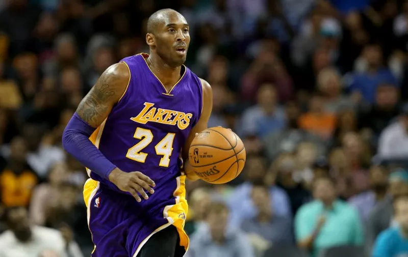 CHARLOTTE, NC - DECEMBER 28: Kobe Bryant #24 of the Los Angeles Lakers brings the ball up the court against the Charlotte Hornets at Time Warner Cable Arena on December 28, 2015 in Charlotte, North Carolina. NOTE TO USER: User expressly acknowledges and agrees that, by downloading and or using this photograph, User is consenting to the terms and conditions of the Getty Images License Agreement.   Streeter Lecka/Getty Images/AFP