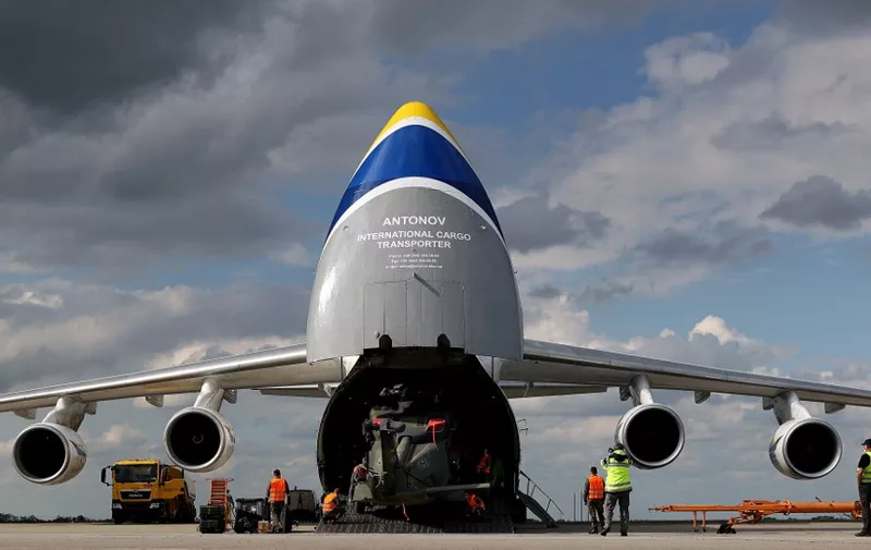 An NH90 military helicopter of the German armed forces (Bundeswehr) is unloaded from an Antonov AN 124 cargo aeroplane shortly after arriving from Afghanistan on May 18, 2021 at the airport of Leipzig, eastern Germany. (Photo by Ronny Hartmann / AFP) / The erroneous mention[s] appearing in the metadata of this photo by Ronny Hartmann has been modified in AFP systems in the following manner: [AN 124] instead of [An-225 Mriya]. Please immediately remove the erroneous mention[s] from all your online services and delete it (them) from your servers. If you have been authorized by AFP to distribute it (them) to third parties, please ensure that the same actions are carried out by them. Failure to promptly comply with these instructions will entail liability on your part for any continued or post notification usage. Therefore we thank you very much for all your attention and prompt action. We are sorry for the inconvenience this notification may cause and remain at your disposal for any further information you may require.