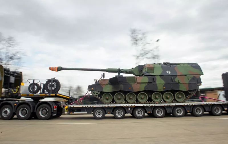 Tanks with mounted howitzers (Panzerhaubitze 2000) of the German armed forces Bundeswehr are loaded onto heavy-duty transporters in the Hindenburg barracks in Munster on February 14, 2022. - Six of the German armoured and self-propelled howitzers will be relocated to Lithuania to reinforce the "Enhanced Forward Presence Battle Group". (Photo by Gregor Fischer / AFP)