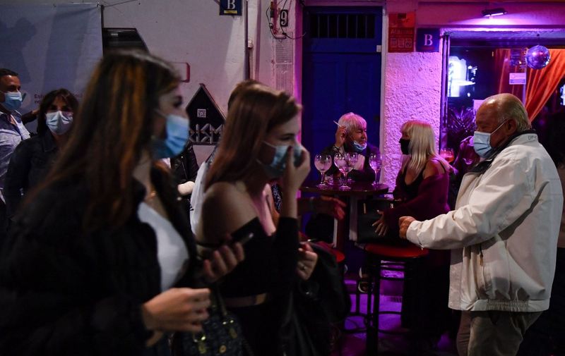 People gather at a terrace bar during a trial clinical study for a possible reopening of nighlife party on May 20, 2021 in Sitges. (Photo by Pau BARRENA / AFP)