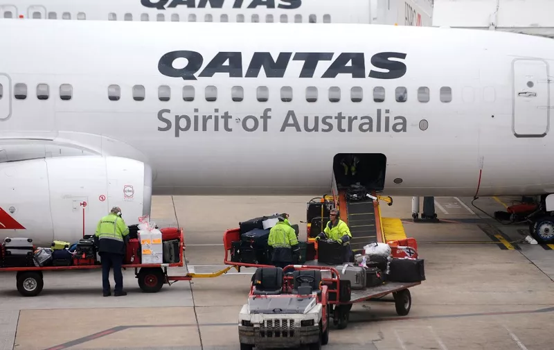 (FILES) A file photo taken in Melbourne on 31 October, 2011 shows bags being loaded onto a Qantas plane. - Qantas Airways posted a 6.5-percent fall in annual net profit on August 22, 2019, attributing the slide in earnings to higher oil prices and a weaker Australian dollar. (Photo by William WEST / AFP)