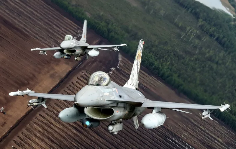 Portuguese Air Force F-16 military fighter jets participate in NATO's Baltic Air Policing Mission in Lithuanian airspace near Siauliai, on May 23, 2023. (Photo by PETRAS MALUKAS / AFP)