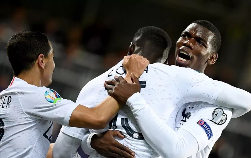 France's defender Kurt Zouma (C) celebrates with his teammate France's midfielder Paul Pogba (R) and France's midfielder Wissam Ben Yedder after scoring during the UEFA Euro 2020 qualification football match between Andorra and France at the National stadium in Andorra La Vella, on June 11, 2019. (Photo by FRANCK FIFE / AFP)