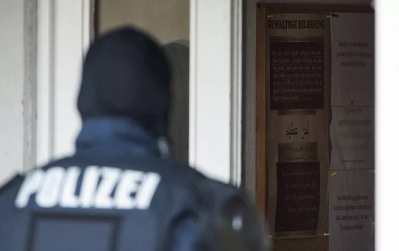 A police officer stands at the antrance of a building of the Mesdschid Sahabe Islamic cultural and educational center during a raid in Stuttgart, southern Germany, on December 17, 2015.
German authorities raided, shuttered and banned the Muslim association and mosque they accused of supporting the Islamic State jihadist group in Syria and Iraq. Police in the southwestern city of Stuttgart confiscated computers, data storage devices, smartphones and documents, said the interior minister of Baden-Wurttemberg state, without reporting any arrests.
 / AFP / dpa / - / Germany OUT