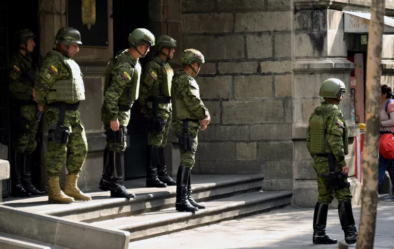 Ecuadorean security forces cordon off the area around the main square and presidential palace after Ecuadorean President Daniel Noboa declared the country in a state of "internal armed conflict" and ordered the army to carry out military operations against the country's powerful drug gangs, in downtown Quito on January 9, 2024. Ecuador's new president, 36-year-old Daniel Noboa, is grappling with a security nightmare after the escape from prison of one of the country's most high profile gangsters, Jose Adolfo Macias, known as "Fito." (Photo by Rodrigo BUENDIA / AFP)