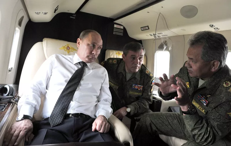TRANSBAIKAL TERRITORY, RUSSIA. JULY 17, 2013. Russia's president Vladimir Putin, Valery Gerasimov, Chief of the General Staff of the Armed Forces of Russia, Defence Minister of Russia Sergey Shoigu, L-R, fly aboard a helicopter over Tsugol firing range.,Image: 166524305, License: Rights-managed, Restrictions: , Model Release: no, Credit line: Profimedia