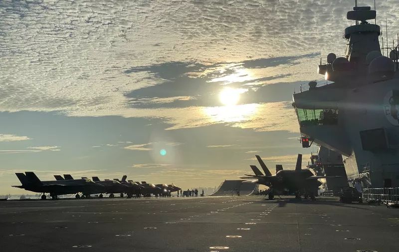 Fighter jets are park on the flight deck onboard UK Carrier Strike Groups HMS Queen Elizabeth docked at Changi Naval Base in Singapore on October 11, 2021. (Photo by CATHERINE LAI / AFP)