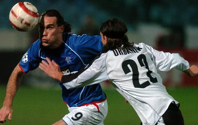 Dado Prso (L) from Glasgow eyes the ball, passing by Ales Urbanek from Artmedia during a Champions League 2005 group H match between Artmedia Bratislava and Glasgow Rangers in Bratislava.

 AFP PHOTO/Jakub Sukup