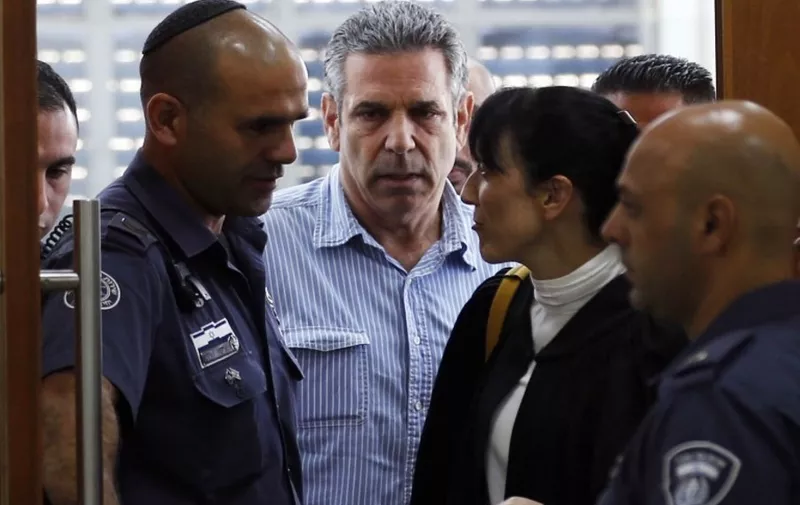 (FILES) In this file photo taken on July 05, 2018 Gonen Segev (C), a former Israeli cabinet minister indicted on suspicion of spying for Iran, is seen in court in Jerusalem. - The Israeli ex-minister was sentenced to 11 years in prison today for spying for his country's main enemy Iran after a plea bargain in the case, the prosecutor said.
Gonen Segev, who served as energy and infrastructure minister from 1995 to 1996, had previously agreed to a plea bargain on charges of serious espionage and transfer of information to the enemy. (Photo by RONEN ZVULUN / POOL / AFP)