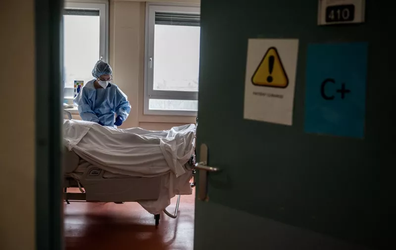 A nurse takes care of a patient surffering from Covid-19 at the intensive care unit of the Centre hospitalier privé de l'Europe in Port-Marly, on March 25, 2021. (Photo by Martin BUREAU / AFP)