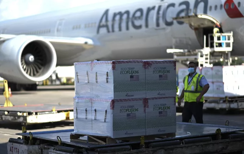 View of boxes with some of the three million doses of the Moderna vaccine against COVID-19 donated by the US after they were unloaded from an American airlines airplane upon its landing at the Aurora International Airport in Guatemala City, on July 20, 2021. (Photo by Johan ORDONEZ / AFP)