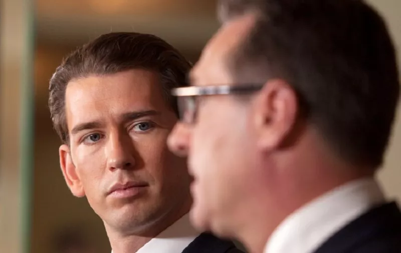 Future Austrian Chancellor Sebastian Kurz of the conservative People's Party (OeVP) listens during a joint press conference with incoming vice-chancellor of the far-right Freedom Party (FPOe) to unveil their joint programme on December 16, 2017 in Vienna, Austria.
Austria's far-right has secured the interior, defence and foreign ministries in the new coalition government with the conservatives, Freedom Party (FPOe) head Heinz-Christian Strache said. Kurz's OeVPy will have the finance, economy and justice ministries, Kurz said. / AFP PHOTO / ALEX HALADA