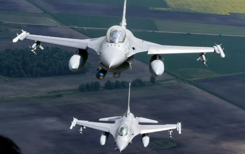 Portuguese Air Force F-16 military fighter jets participate in NATO's Baltic Air Policing Mission in Lithuanian airspace near Siauliai, on May 23, 2023. (Photo by Petras Malukas / AFP)