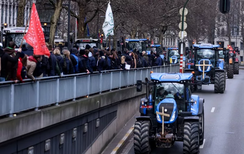 Protesters ride tractors during a demonstration called by Flemish farmers to protest against new rules to reduce nitrogen emissions in Brussels, on March 3, 2023. (Photo by Kenzo TRIBOUILLARD / AFP)