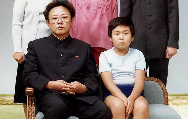 (FILES) This file handout photo taken on August 19, 1981 and released to AFP in 2000 shows North Korean leader Kim Jong-Il (sitting-L) with his son, Kim Jong-Nam (sitting-R), for a family portrait in Pyongyang.
The half-brother of North Korean leader Kim Jong-Un, who has been murdered in Malaysia, pleaded for his life after a failed assassination bid in 2012, lawmakers briefed by South Korea's spy chief said on February 15, 2017. Jong-Nam, the eldest son of the late former leader Kim Jong-Il, was once seen as heir apparent but fell out of favour following an embarrassing botched bid in 2001 to enter Japan on a forged passport and visit Disneyland. / AFP PHOTO / Handout /  - South Korea OUT - North Korea OUT