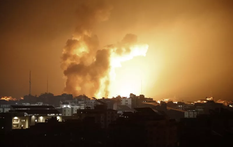 Fire and smoke rises above buildings during an Israeli air strike in Gaza City on October 8, 2023. At least 200 Israelis died in a surprise large-scale attack by the Palestinian militant group Hamas on October 7, 2023, the army said, as Prime Minister Benjamin Netanyahu vowed to reduce the group's Gaza hideouts to "rubble". (Photo by EYAD BABA / AFP)