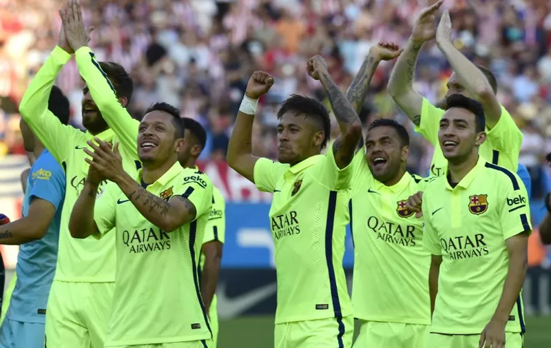 Barcelona's players celebrate winning the Spanish Liga Champion and the match after the Spanish league football match Club Atletico de Madrid vs FC Barcelona at the Vicente Calderon stadium in Madrid on May 17, 2015.    AFP PHOTO / 