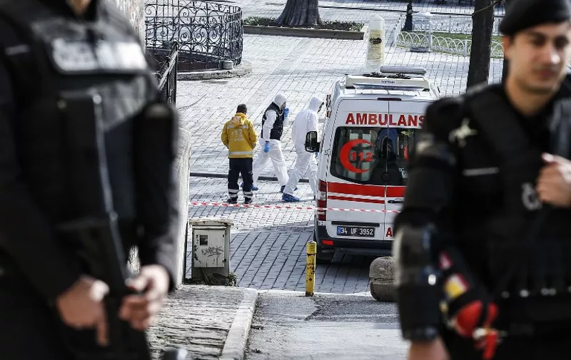 Forensic experts walk near the site of a blast in the Blue Mosque area in Istanbul's tourist hub of Sultanahmet on January 12, 2016.
At least 10 people were killed and 15 wounded in a suspected terrorist attack in the main tourist hub of Turkey's largest city Istanbul, officials said. A powerful blast rocked the Sultanahmet neighbourhood which is home to Istanbul's biggest concentration of monuments and and is visited by tens of thousands of tourists every day. / AFP / BULENT KILIC