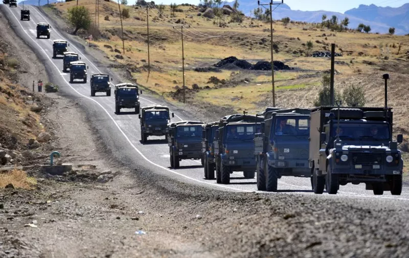 Photo taken on October 22, 2011 shows a Turkish army convoy on a road in the province of Sirnak, near the Turkish-Iraqi border in southeastern Turkey. The conflict between Turkey and north Iraq-based Kurdish rebels has turned the town of Shila Dizah into a "prison," limiting movement and keeping residents from their farms. AFP PHOTO / MUSTAFA OZER / AFP / MUSTAFA OZER