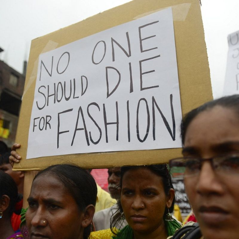 Relatives of Bangladeshi workers who lost their lives in the nine-storey Rana Plaza garment factory building collapse, gather with banners and placards in Savar, on the outskirts of Dhaka on June 29, 2013, at the site of Bangladesh's worst industrial disaster. Activists are set to protest across North America and Europe as they attempt to force the clothing retail giants Gap and Walmart into signing an 'Accord on Fire and Building Safety in Bangladesh', which holds corporations legally responsible for the safety of garment workers in the South Asian nation.   Bangladeshi officials have said Dhaka has enacted a series of reforms since the April 24, collapse of a factory complex in which 1,129 people were killed -- the latest in a series of disasters to blight the industry.    AFP PHOTO/Munir uz ZAMAN (Photo by Munir UZ ZAMAN / AFP)