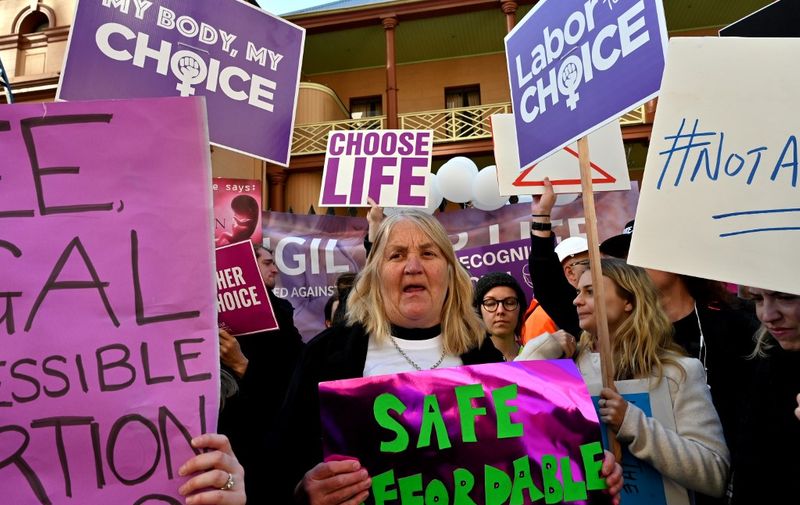 Pro-life and pro-choice advocates hold a protest rally outside the New South Wales Parliament in Sydney on August 6, 2019. - Scores of protestors gathered outside the NSW Parliament ahead of debate on Reproductive Health Care Reform Bill. (Photo by Saeed KHAN / AFP)