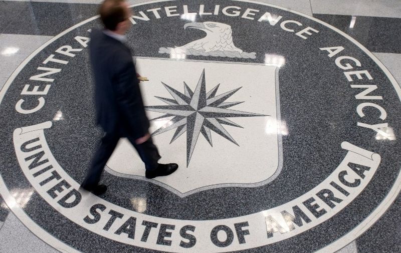 A man crosses the Central Intelligence Agency (CIA) logo in the lobby of CIA Headquarters in Langley, Virginia, on August 14, 2008. AFP PHOTO/SAUL LOEB
