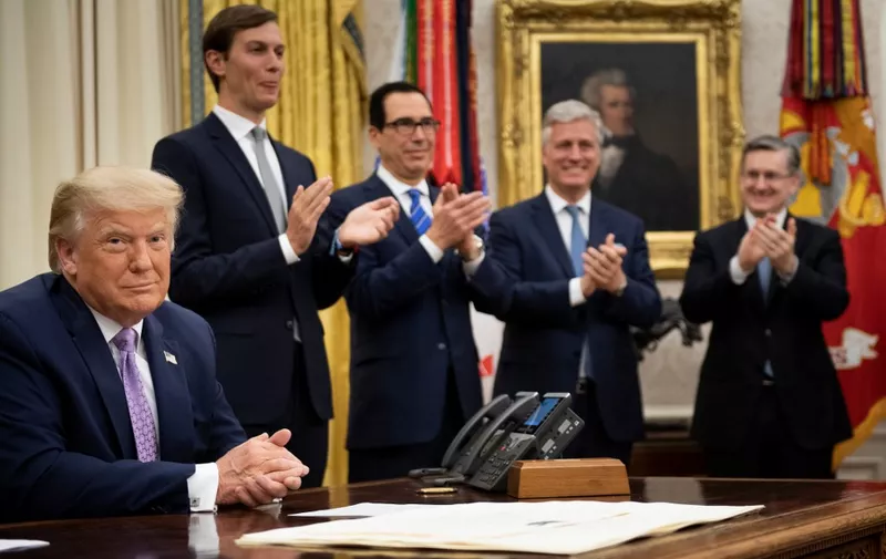 (L-R, rear) Senior Advisor Jared Kushner, US Secretary of the Treasury Steven Mnuchin and National Security Advisor Robert O'Brien clap for US President Donald Trump (L) after he announced an agreement between the United Arab Emirates and Israel to normalize diplomatic ties, the White House August 13, 2020, in Washington, DC. - Trump on Thursday made the surprise announcement of a peace agreement between Israel and the United Arab Emirates. The normalization of relations between the UAE and Israel is a "HUGE breakthrough" Trump tweeted, calling it a "Historic Peace Agreement between our two GREAT friends." (Photo by Brendan Smialowski / AFP)
