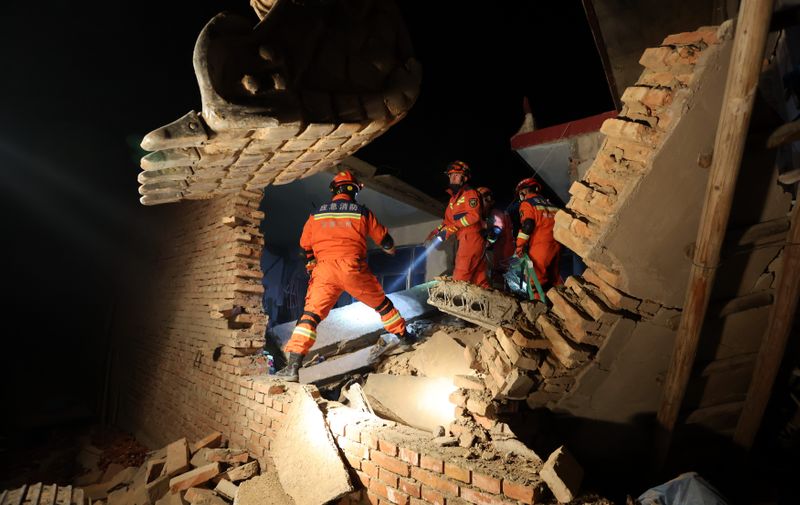 Rescuers work on the rubble of a house that collapsed in the earthquake in Kangdiao village of Jishishan county in northwest China's Gansu province Tuesday, Dec. 19, 2023. A magnitude-6.2 earthquake jolted the remote and mountainous county around midnight on Tuesday, killing at least 111 people and injuring more than 230, according to Chinese state media.,Image: 830718909, License: Rights-managed, Restrictions: CHINA OUT, Model Release: no