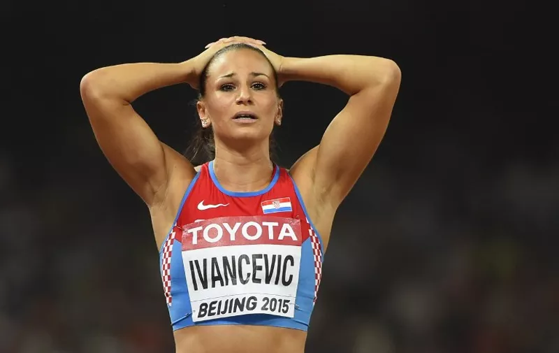 Croatia's Andrea Ivancevic reacts after falling in her semi-final of the women's 100 metre hurdles athletics event at the 2015 IAAF World Championships at the "Bird's Nest" National Stadium in Beijing on August 28, 2015.    AFP PHOTO / OLIVIER MORIN