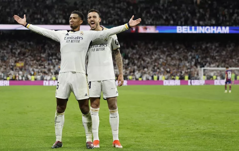Real Madrid's English midfielder #5 Jude Bellingham celebrates scoring his team's third goal, with Real Madrid's Spanish forward #14 Joselu, during the Spanish league football match between Real Madrid CF and FC Barcelona at the Santiago Bernabeu stadium in Madrid on April 21, 2024. (Photo by OSCAR DEL POZO / AFP)