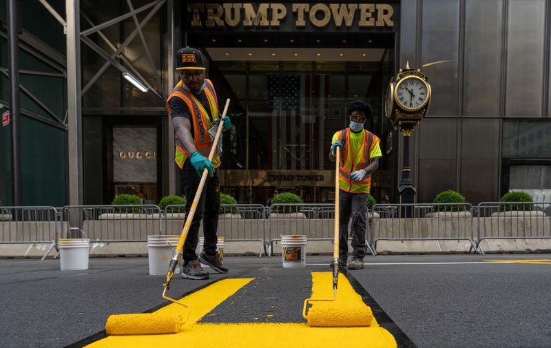 NEW YORK, NY - JULY 09: Crews begin painting a Black Lives Matter mural on Fifth Avenue directly in front of Trump Tower on July 9, 2020 in New York City. In a tweet, President Trump called the mural a "symbol of hate" and said that it would be "denigrating this luxury Avenue".   David Dee Delgado/Getty Images/AFP