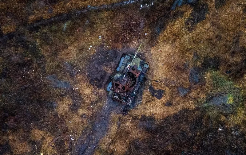 This aerial photograph shows a destroyed tank in a field in the village of Kamenka, Kharkiv region on February 26, 2023, amid the Russian invasion of Ukraine. (Photo by Ihor TKACHOV / AFP)