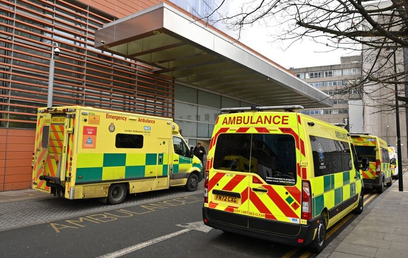 Ambulances are seen queued outside the Royal London hospital in east London on January 29, 2023. (Photo by JUSTIN TALLIS / AFP)