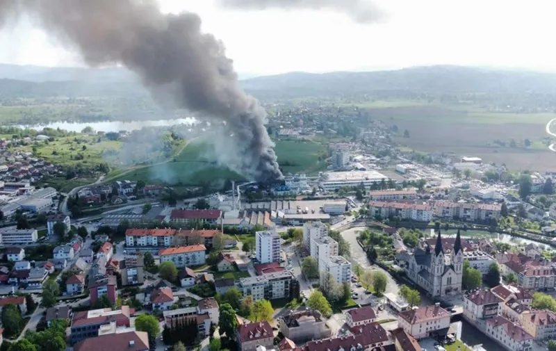 A picture taken on May 12, 2022 shows columns of black smoke billowing from the factory of resin supplier Melamin, where a cistern exploded for unknown reason, sparking a fire and killing five people. The factory is located in Kocevje municipality, some 60 kilometres (40 miles) south of Ljubljana. (Photo by Mitja Ofak / STA FOTO / AFP)