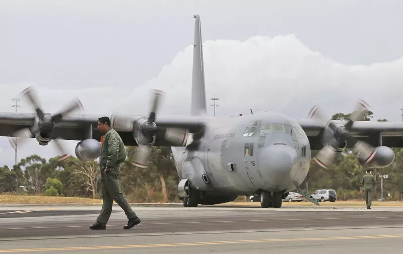 A Royal Malaysian Air Force C-130 Hercules lands at RAAF Base Pearce to to help with the search for debris or wreckage of the missing Malaysia Airlines Flight MH370 in Perth on March 29, 2014. Ship and plane crews on March 29 searched a vast new area of the Indian Ocean for wreckage from a Malaysian plane which went missing three weeks ago, seeking closure for relatives and clues to the crash. AFP PHOTO / POOL / Rob GRIFFITH (Photo by ROB GRIFFITH / POOL / AFP)