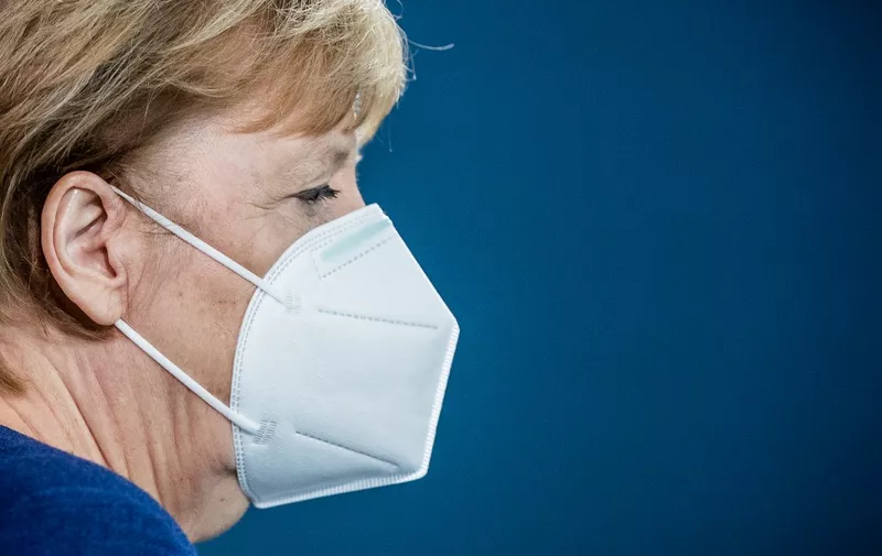 German Chancellor Angela Merkel arrives wearing a face mask to deliver a statement on the outcome of the presidential election in the United States of America, on November 9, 2020 in Berlin. (Photo by Michael Kappeler / POOL / AFP)