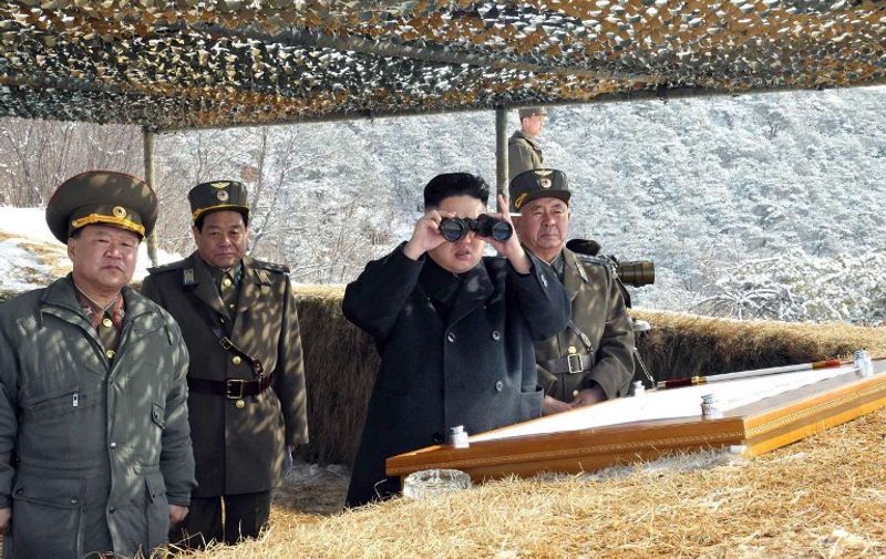 This picture taken by North Korea's official Korean Central News Agency on March 20, 2013 shows North Korean leader Kim Jong-Un (2nd R) using binoculars to inspect a live fire drill using self-propelled drones at an undisclosed location in North Korea. Kim oversaw the live fire military drill using drones and cruise missile interceptors, state media said on March 20, amid heightened tensions on the Korean peninsula. AFP PHOTO / KCNA via KNS
---EDITORS NOTE--- RESTRICTED TO EDITORIAL USE - MANDATORY CREDIT "AFP PHOTO / KCNA VIA KNS" - NO MARKETING NO ADVERTISING CAMPAIGNS - DISTRIBUTED AS A SERVICE TO CLIENTS / AFP / KCNA / KNS