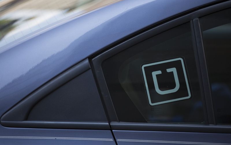 The Uber logo is seen on a car in Washington, DC, on July 9, 2019. (Photo by Alastair Pike / AFP)