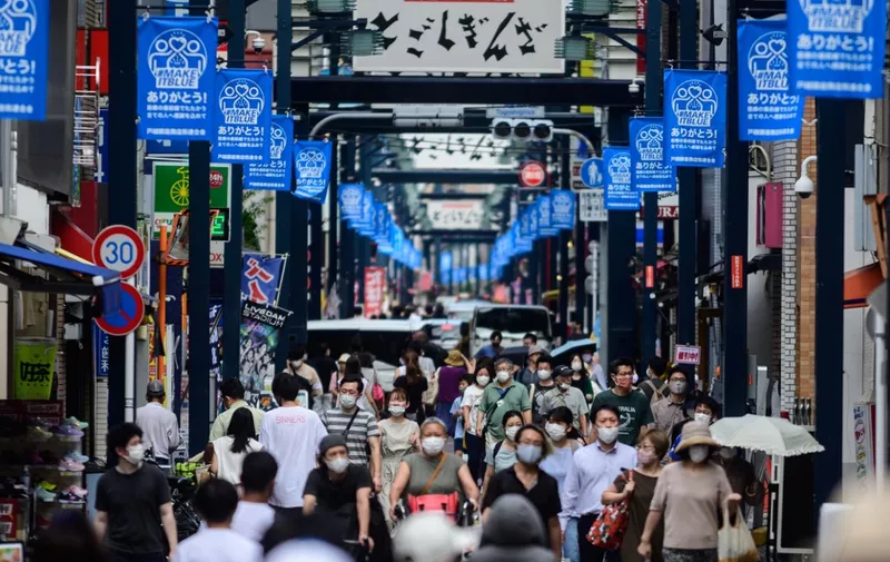 People wearing face masks as a preventive measure against the COVID-19 coronavirus visit Togoshi Ginza shopping street in Tokyo on August 1, 2020. (Photo by Philip FONG / AFP)