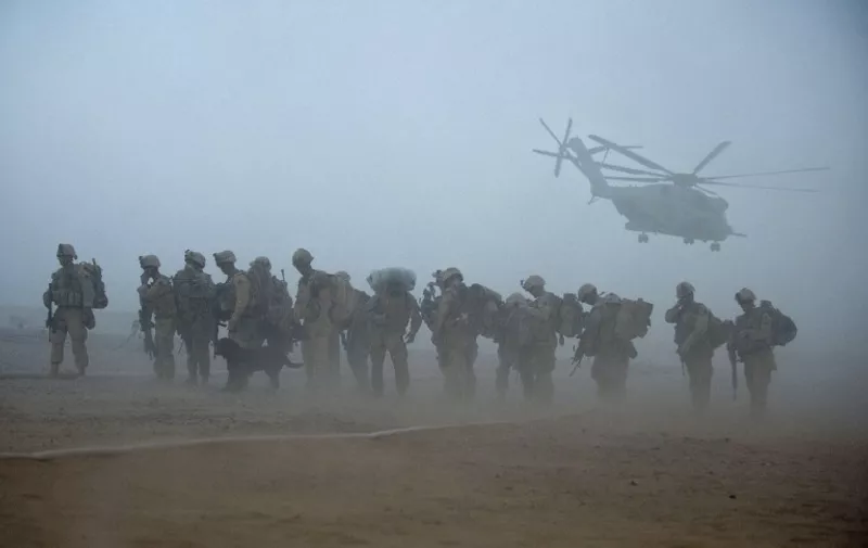 (FILES) In this photograph taken on July 2, 2009, US Marines from the 2nd Battalion, 8th Marine Regiment of the 2nd Marine Expeditionary Brigade wait for helicopter transport as part of Operation Khanjar at Camp Dwyer in Afghanistan's Helmand Province. Kabul welcomed the US decision to keep thousands of troops in Afghanistan past 2016, vowing to respond to a resurgent Taliban "with full force" even as the rebels promised to wage jihad until the last American soldier leaves. AFP PHOTO / Manpreet ROMANA / FILES
