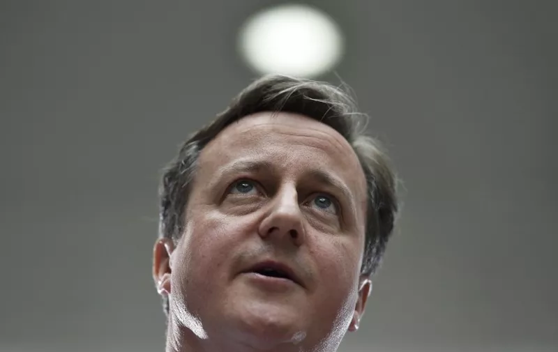 British Prime Minister David Cameron addresses workers during a UK general election campaign event at ASDA supermarket's headquarters in Leeds, northern England on May 1, 2015. Britain could face days or even weeks of negotiations to form a new government after elections on May 7, with opinion polls suggesting that no one party will win outright. AFP PHOTO / POOL / Toby Melville