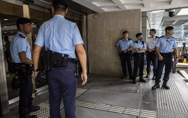 Police stand guard outside the High Court in Hong Kong on July 21, 2023, as the government seeks an injunction to have the protest song Glory to Hong Kong banned. (Photo by ISAAC LAWRENCE / AFP)