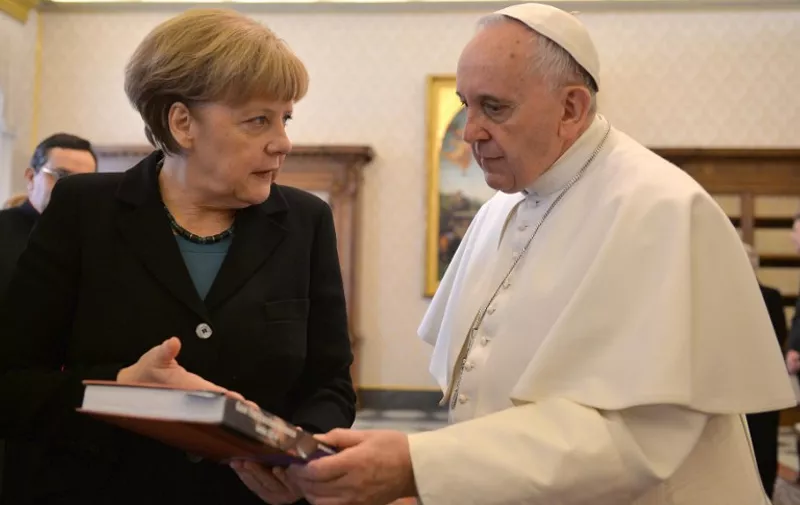 Pope Francis speaks with Angela Merkel, Chancellor of Germany, during a private audience in the pontiff's library, in the Vatican City, on February 21, 2015. AFP PHOTO /ANSA / MAURIZIO  BRAMBATTI