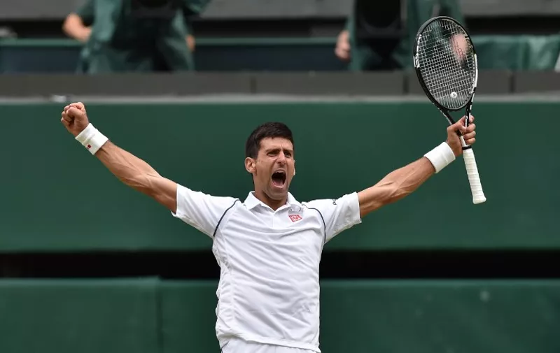 Serbia's Novak Djokovic celebrates beating Switzerland's Roger Federer during their men's singles final match on Centre Court on day thirteen of the 2015 Wimbledon Championships at The All England Tennis Club in Wimbledon, southwest London, on July 12, 2015. Djokovic won the match 7-6, 6-7, 6-7, 6-4.   RESTRICTED TO EDITORIAL USE  --   / 