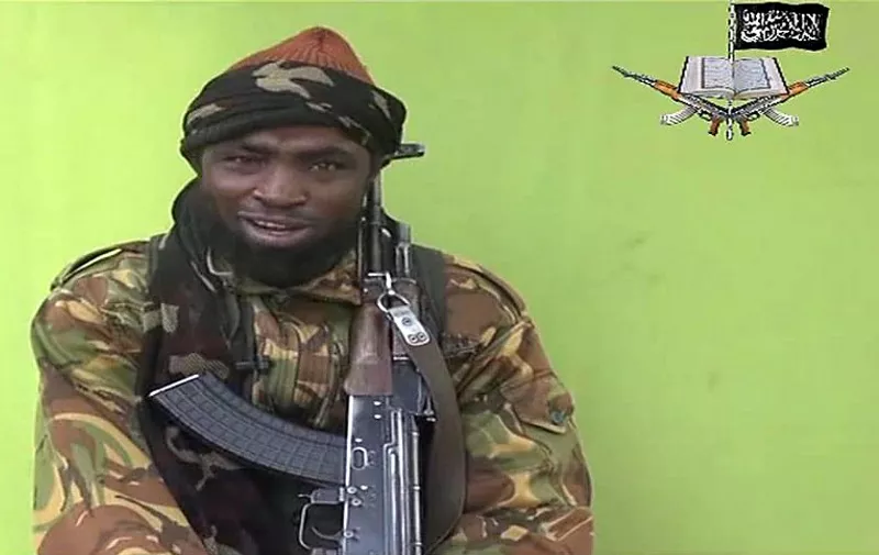 A screengrab taken on May 12, 2014, from a video released by Nigerian Islamist extremist group Boko Haram and obtained by AFP shows a man claiming to be the leader of Nigerian Islamist extremist group Boko Haram Abubakar Shekau. Boko Haram released a new video on claiming to show the missing Nigerian schoolgirls, alleging they had converted to Islam and would not be released until all militant prisoners were freed.  Abubakar Shekau speaks on the video obtained by AFP for 17 minutes before showing what he said were about 130 of the girls, wearing the full-length hijab and praying in an undisclosed rural location. A total of 276 girls were abducted on April 14 from the northeastern town of Chibok, in Borno state, which has a sizeable Christian community. Some 223 are still missing. AFP PHOTO / BOKO HARAM 
RESTRICTED TO EDITORIAL USE - MANDATORY CREDIT "AFP PHOTO / BOKO HARAM" - NO MARKETING NO ADVERTISING CAMPAIGNS - DISTRIBUTED AS A SERVICE TO CLIENTS / AFP PHOTO / BOKO HARAM / HO