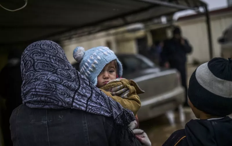 Refugees wait near the Turkish border crossing gate as Syrians fleeing the northern embattled city of Aleppo wait on February 6, 2016 in Bab al-Salama, near the city of Azaz, northern Syria.
Thousands of Syrians were braving cold and rain at the Turkish border Saturday after fleeing a Russian-backed regime offensive on Aleppo that threatens a fresh humanitarian disaster in the country's second city. Around 40,000 civilians have fled their homes over the regime offensive, according to the Syrian Observatory for Human Rights monitor. / AFP / BULENT KILIC