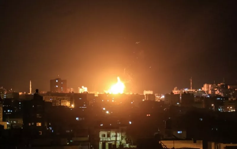 An explosion is seen in northern Gaza City after an airstrike by Israeli forces on June 20, 2018. 
Israeli fighter jets hit 25 targets in the Gaza Strip early June 20 in response to rocket fire from the Palestinian territory, the army said.
 / AFP PHOTO / ABED ABU RYASH