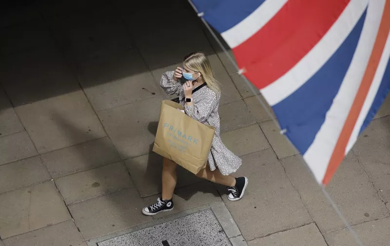 A shopper wears a face mask on Oxford Street om London on July 24, 2020, after wearing facemasks in shops and supermarkets became compulsory in England as a measure to combat the spread of the novel coronavirus. (Photo by Tolga AKMEN / AFP)